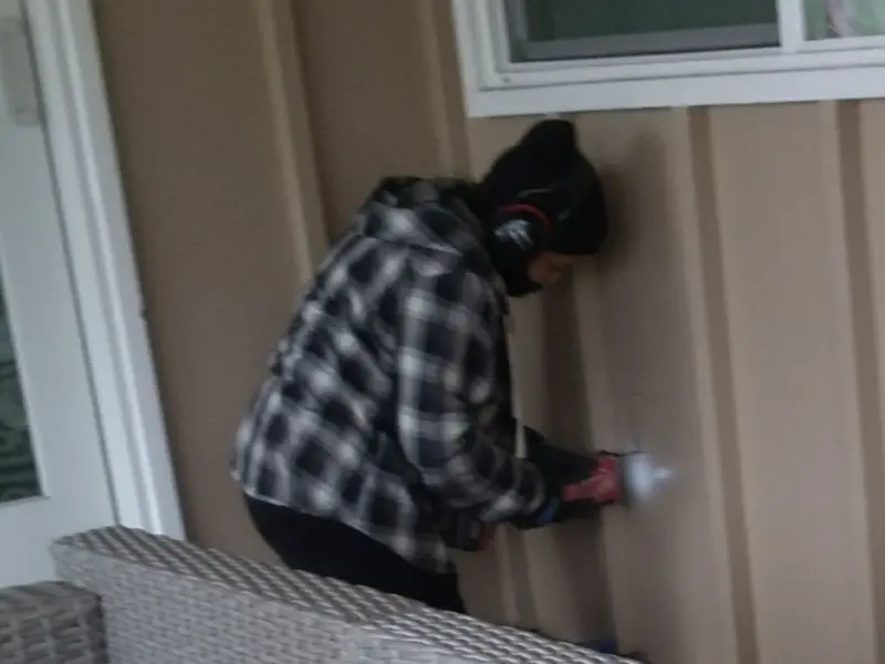 Professional electrician installing an exterior outlet in Lakewood